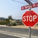 Image of Spring Street road sign with Stop Sign.